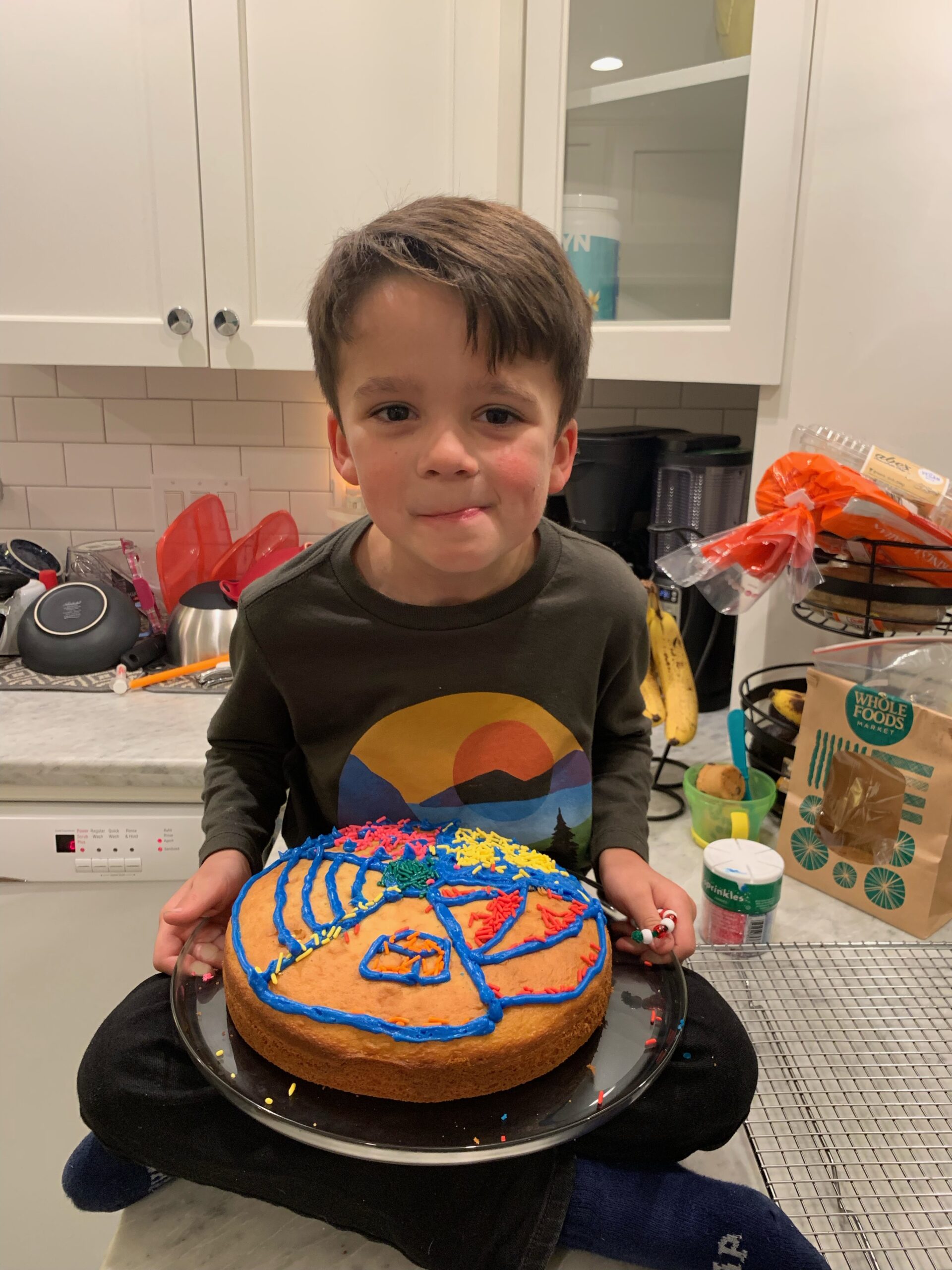 Photo of Tim's son with self-decorated cake